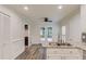 Bright kitchen features granite counters, stainless faucet, and access to an outdoor patio at 6006 Lanier Heights Cir, Buford, GA 30518