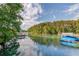 Scenic lake view featuring docks and lush shoreline with boats, creating a serene ambiance at 6006 Lanier Heights Cir, Buford, GA 30518