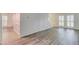 Open living room featuring a staircase, elegant gray wood flooring and a window at 6006 Lanier Heights Cir, Buford, GA 30518