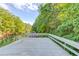 Pier with a gray deck offering scenic views of the surrounding lake and lush trees at 6006 Lanier Heights Cir, Buford, GA 30518