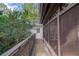 View of a covered porch with railing and access door to the home at 6006 Lanier Heights Cir, Buford, GA 30518