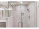 Modern bathroom featuring glass shower doors and tiled shower with built-in niche at 6006 Lanier Heights Cir, Buford, GA 30518