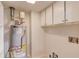 Clean utility room with white cabinets and newer hot water heater at 6006 Lanier Heights Cir, Buford, GA 30518