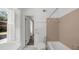 Bright bathroom featuring a bathtub and shower, vintage tiles, and natural light through shuttered window at 789 Houston Mill Ne Rd # 5, Atlanta, GA 30329