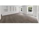 Spacious room featuring gray carpeting, built-in shelving, and natural light from two windows at 789 Houston Mill Ne Rd # 5, Atlanta, GA 30329
