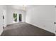 Dining area with light-filled French doors to deck, carpet, and white walls at 789 Houston Mill Ne Rd # 5, Atlanta, GA 30329