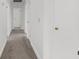 Clean hallway with white trim, carpet, and white doors offering access to different areas of the house at 789 Houston Mill Ne Rd # 5, Atlanta, GA 30329