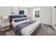 Stylish main bedroom featuring a plush bed, nightstands, lamps, and a view to the outdoors at 789 Houston Mill Ne Rd # 5, Atlanta, GA 30329