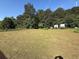 Spacious backyard with lush greenery and clear skies at 124 Tyler Dr, Mcdonough, GA 30252