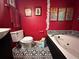Red bathroom with a jacuzzi tub and black-and-white patterned floors for a unique aesthetic at 124 Tyler Dr, Mcdonough, GA 30252