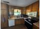 Efficient kitchen with stainless steel appliances and wooden cabinets with laminate floor at 124 Tyler Dr, Mcdonough, GA 30252