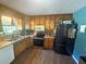 Efficient kitchen with stainless steel appliances and wooden cabinets with laminate floor at 124 Tyler Dr, Mcdonough, GA 30252