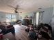 Cozy living room with fireplace, ceiling fan, large window, and natural light at 124 Tyler Dr, Mcdonough, GA 30252