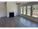 Spacious living room with a fireplace, ceiling fan, hardwood floors, and lots of natural light at 214 Saratoga Dr, Acworth, GA 30102