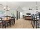 Bright dining area featuring an elegant chandelier, hardwood floors, and a view to the living room and backyard at 4068 Cottage Oaks Dr, Acworth, GA 30101