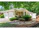 Inviting front yard featuring lush greenery, stone pathway, and cozy seating area at 4068 Cottage Oaks Dr, Acworth, GA 30101