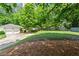 Charming home featuring an attached two-car garage and a spacious, well-maintained front yard with mature trees at 4068 Cottage Oaks Dr, Acworth, GA 30101