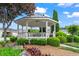 This picturesque gazebo is surrounded by lush landscaping with a sidewalk and neighborhood homes in the backdrop at 4068 Cottage Oaks Dr, Acworth, GA 30101