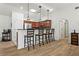 Kitchen featuring breakfast bar, hardwood floors, stainless steel appliances, skylights, and pendant lighting at 4068 Cottage Oaks Dr, Acworth, GA 30101