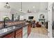 Open-concept kitchen with stainless steel appliances, granite counters, and views of the living room and fireplace at 4068 Cottage Oaks Dr, Acworth, GA 30101