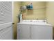 Efficient laundry area with front-loading washer and dryer and storage shelving at 4068 Cottage Oaks Dr, Acworth, GA 30101