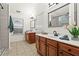 Bathroom featuring double vanity, tile floors, large mirror, walk-in shower, and a bright window at 4068 Cottage Oaks Dr, Acworth, GA 30101