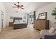 Bedroom with wood floors, ceiling fan, patio door, large dresser, and a view to the backyard at 4068 Cottage Oaks Dr, Acworth, GA 30101