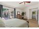 Main bedroom with wood floors, access to screened in back porch, ceiling fan and view to the Primary bathroom at 4068 Cottage Oaks Dr, Acworth, GA 30101