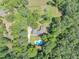 Aerial view displaying the property, pool, surrounding trees, and expansive land at 4820 Yeager Rd, Douglasville, GA 30135