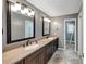 Bathroom featuring a dual sink vanity, dual mirrors and lighting, and neutral finishes at 4820 Yeager Rd, Douglasville, GA 30135