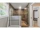 Modern bathroom features a large glass shower with a built-in bench and tiled walls at 4820 Yeager Rd, Douglasville, GA 30135