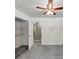 This bedroom is bright and features neutral walls and carpet and a ceiling fan at 4820 Yeager Rd, Douglasville, GA 30135