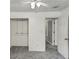 This bedroom features neutral carpet, a ceiling fan, and closet and doorway access at 4820 Yeager Rd, Douglasville, GA 30135