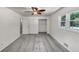 This bedroom is bright and features neutral walls and carpet and a ceiling fan at 4820 Yeager Rd, Douglasville, GA 30135