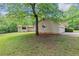 Ranch-style home with a light-colored exterior, mature tree, and a well-maintained lawn at 4820 Yeager Rd, Douglasville, GA 30135