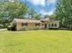 Charming ranch-style home with a well-maintained lawn, mature trees, and covered parking at 4820 Yeager Rd, Douglasville, GA 30135
