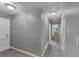 This hallway features neutral gray walls and carpet leading to another room at 4820 Yeager Rd, Douglasville, GA 30135