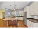 Contemporary kitchen showcases a large island cooktop, and stainless steel appliances at 4820 Yeager Rd, Douglasville, GA 30135