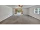 Large living room featuring neutral carpet, white walls, and a ceiling fan at 4820 Yeager Rd, Douglasville, GA 30135