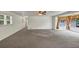 Spacious living room featuring neutral carpet, white walls, and a ceiling fan at 4820 Yeager Rd, Douglasville, GA 30135