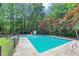 Sparkling pool surrounded by lush greenery, ideal for summer relaxation and fun at 4820 Yeager Rd, Douglasville, GA 30135