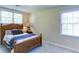 Bright bedroom featuring a wooden bed frame, soft carpet, and lots of natural light from the windows at 118 Valleyside S Dr, Dallas, GA 30157