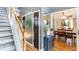 Welcoming foyer with hardwood floors, staircase, and stylish decor leading to a dining room at 118 Valleyside S Dr, Dallas, GA 30157