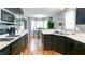 Stylish kitchen with black appliances, white countertops, and casual dining area with natural light at 118 Valleyside S Dr, Dallas, GA 30157