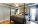 This main bedroom boasts a four-poster bed, tray ceilings, and a private entrance to the back deck at 118 Valleyside S Dr, Dallas, GA 30157