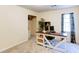 The office has neutral carpet, a computer desk, a chair, and window with curtains at 118 Valleyside S Dr, Dallas, GA 30157