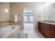 A stylish bathroom with a tub and an elegant view to the main bedroom at 2227 W Village Se Ln, Smyrna, GA 30080