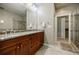 A bathroom featuring a double vanity with granite countertops and a glass-enclosed shower at 2227 W Village Se Ln, Smyrna, GA 30080