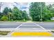 Street crosswalk providing safe pedestrian access to the community path, enhancing walkability and connectivity at 2227 W Village Se Ln, Smyrna, GA 30080