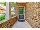 Close-up of the brick entryway with a stylish front door and covered porch at 2227 W Village Se Ln, Smyrna, GA 30080
